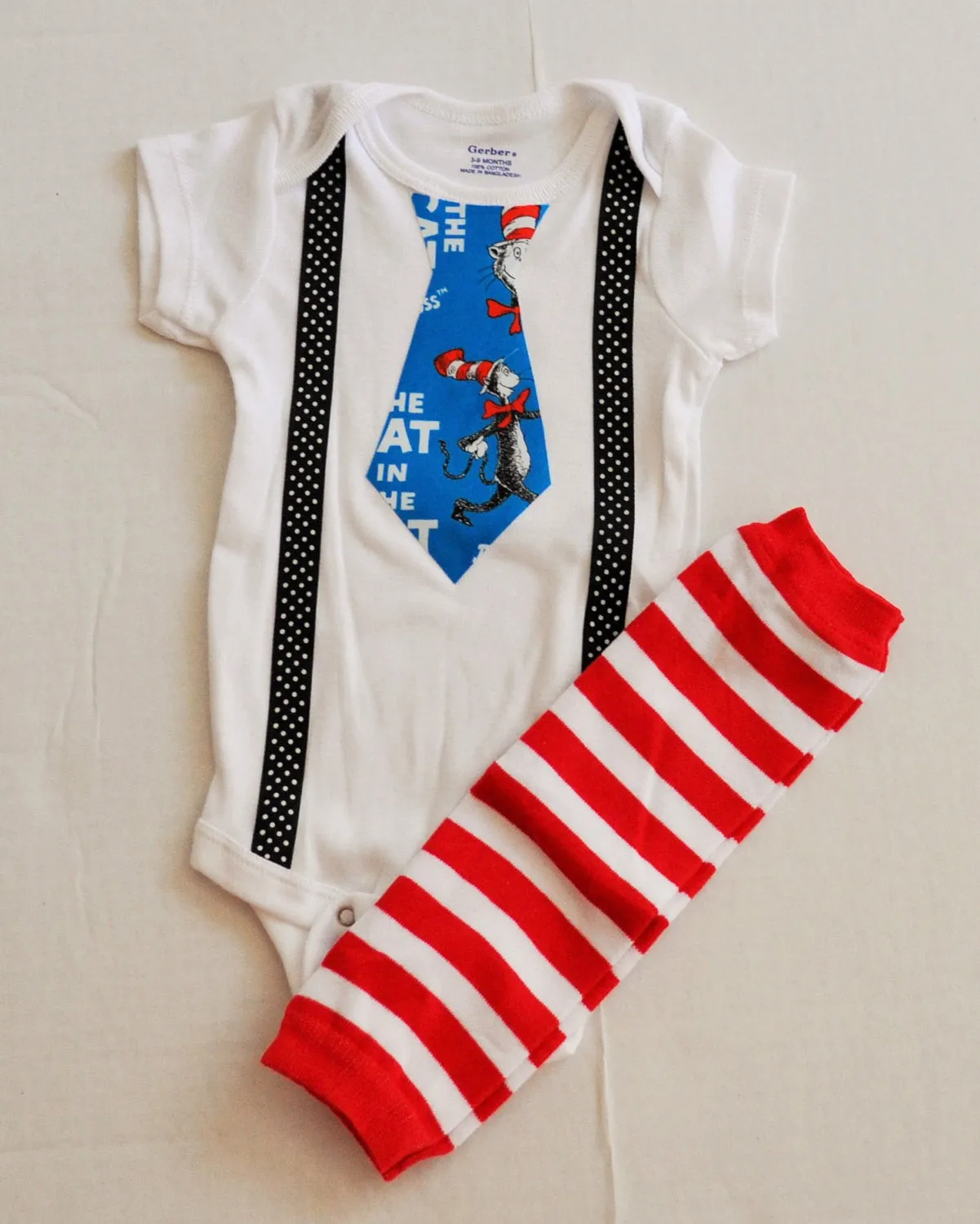 Dr. Seuss cake smash bodysuit Dr Suess smash cake tie and black with white polka dot suspenders with Red and White Striped Baby Leg Warmers