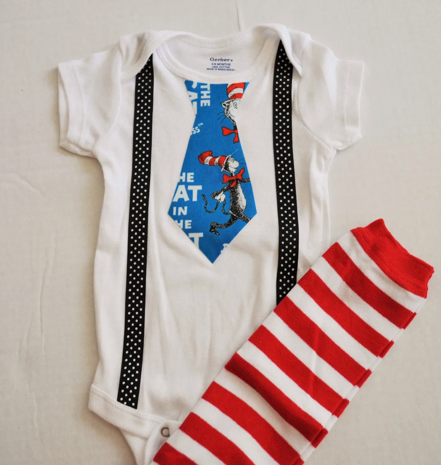 Dr. Seuss cake smash bodysuit Dr Suess smash cake tie and black with white polka dot suspenders with Red and White Striped Baby Leg Warmers